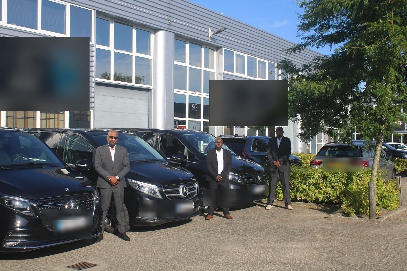 Three V-Class vans and chauffeurs outside the production studio