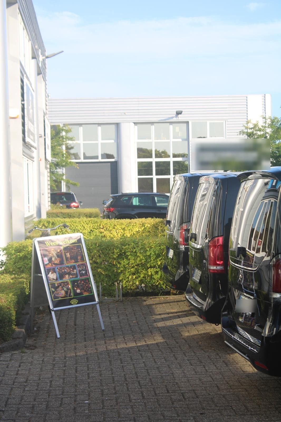 Vans staged at the venue entrance before load-in