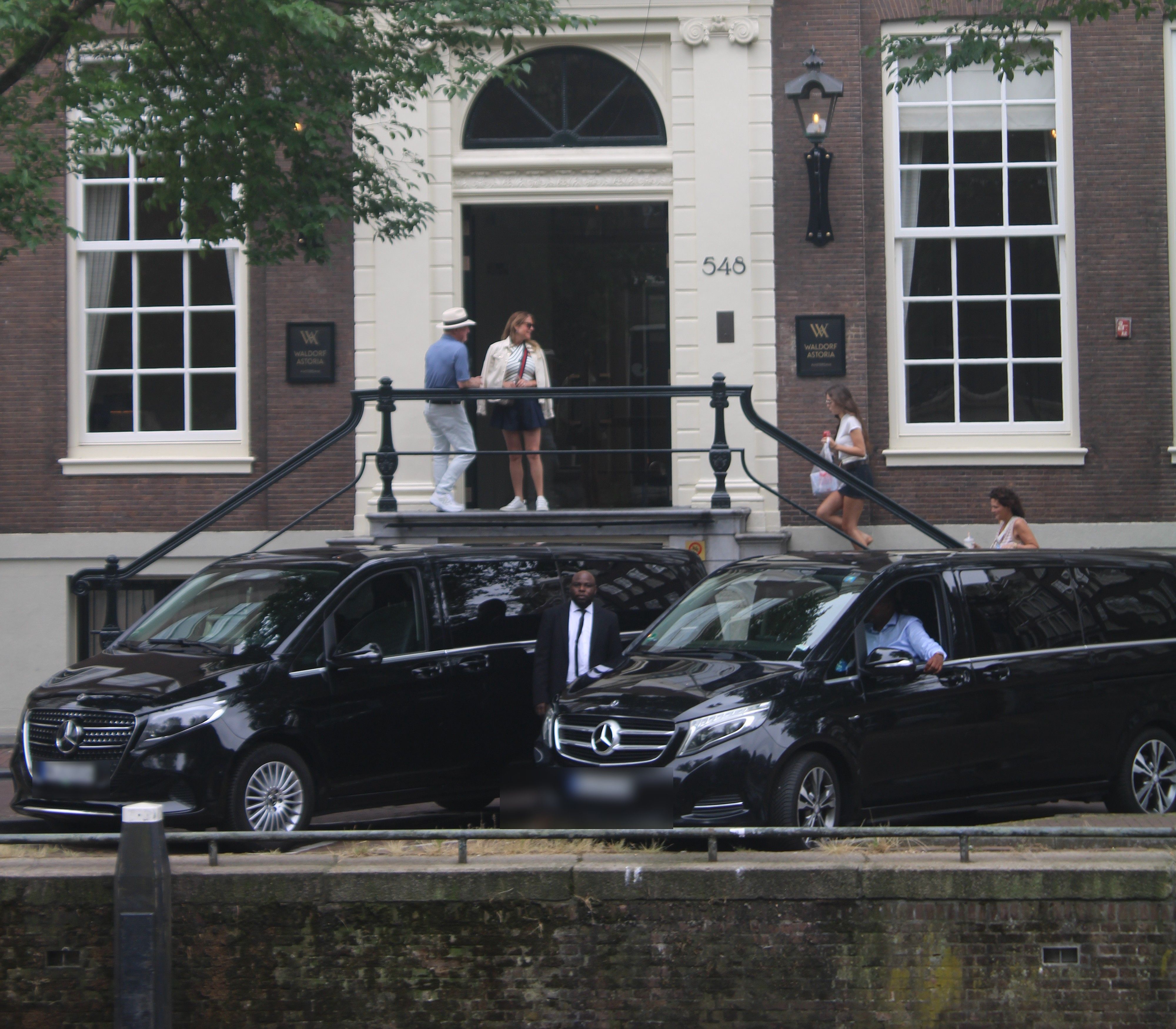 Class One chauffeurs with two V-Class vans at the hotel entrance